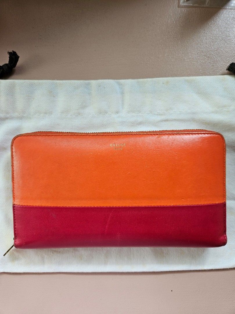 Céline zipped mulitfunction wallet (Category: Luxury Bags & Wallets) located in Manila. Submitted by cneshop (Listing ID 1316304884, Image 3). Description: •CÉLINE zipped multifunction wallet •orange and magenta color w/ gold hardware •complete with dust bag and cards.