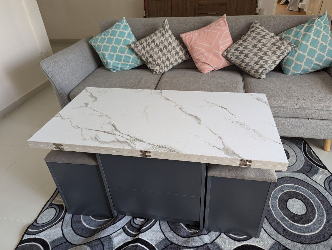 Multi function Coffee Table (Category: Tables & Sets) located in Singapore. Submitted by amiyap (Listing ID 1316470278, Image 1). Description: Lightly Used Multifunction Coffee Table. Opens up to a big size of 110cmx105cm. Folds down to coffee table size. Storage unit is NOT included German Hydrolic Technology for smooth closing action. New one costs around $1000 Just one year old. will include two wheel sets for free. Selling as moving out..