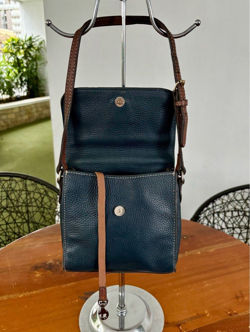 Dooney & Bourke Saffiano Letter Carrier (Category: Cross-body Bags) located in Pasig City. Submitted by lexans_bentables (Listing ID 1316681142, Image 3). Description: Authentic Dooney & Bourke Saffiano Letter Carrier bag ❣️ CLEARANCE SALE ❣️ - saffiano leather - magnetic snap enclosure - one outside pocket, one inside zip pocket - 7.25 in x 2.75 in x 7.25 in - normal signs of use (e.g., scratches) - no peeling or cracking parts NOTE❗️❗️❗️ - inte