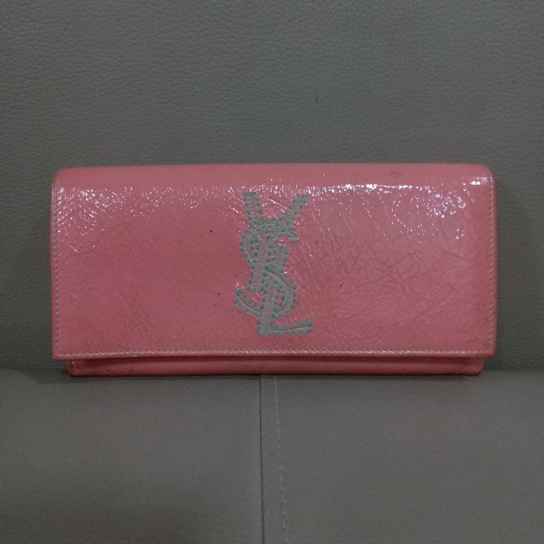 YSL Peach Bi Fold Long Wallet (Category: Luxury Bags & Wallets) located in Taguig. Submitted by esa.agustin (Listing ID 1316671363, Image 1). Description: Original YSL peach patent leathet bi fold long wallet. Made in Italy..