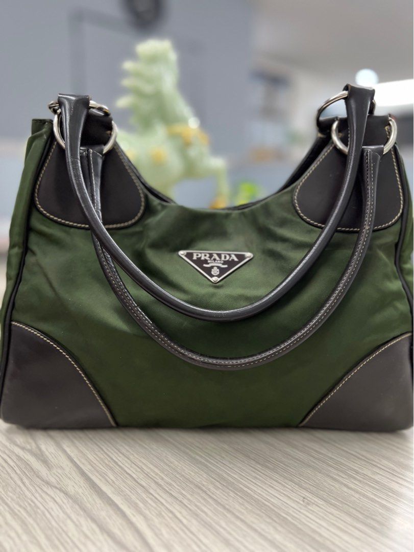 Authentic Prada Nylon Bag (Category: Luxury Bags & Wallets) located in Cagayan de Oro. Submitted by riggstuffs (Listing ID 1316986048, Image 1). Description: ➡️ guaranteed Authentic Prada Nylon bag in army green color Made in Italy With code Nylon material has no discoloration, leather is good. Interior area is clean No other inclusion Disclaimer : Riggstuffs is not associated or affiliated with the brand posted. All copyrights and trademarks bel