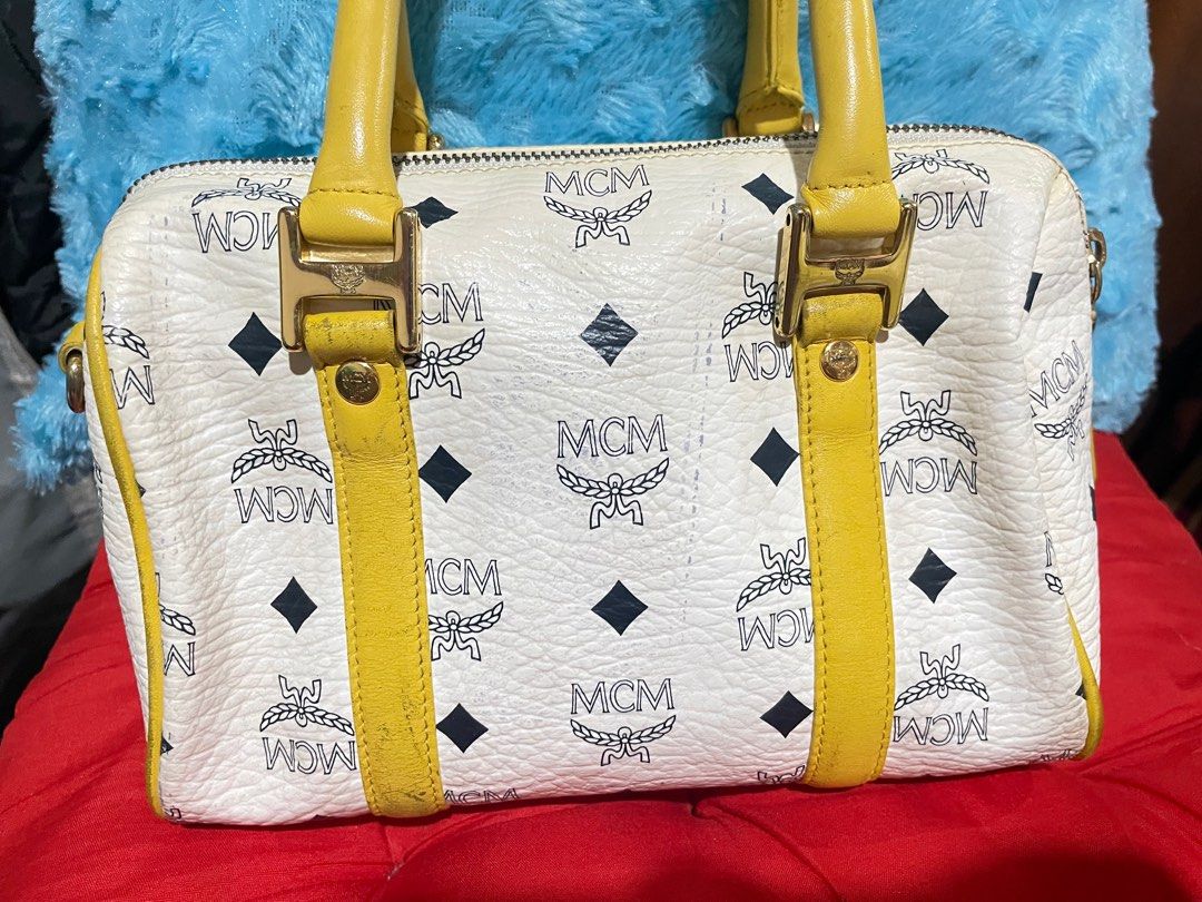 MCM (Category: Luxury Bags & Wallets) located in Pasay City. Submitted by hearty12 (Listing ID 1316847677, Image 3). Description: Small sling doctors bag. Yellow and white color. With transfer color at the back and no available sling. Turnable screw, needs cleaning inside. Some rubs in the handle Length-9inches Height-7 inches Last price na po..