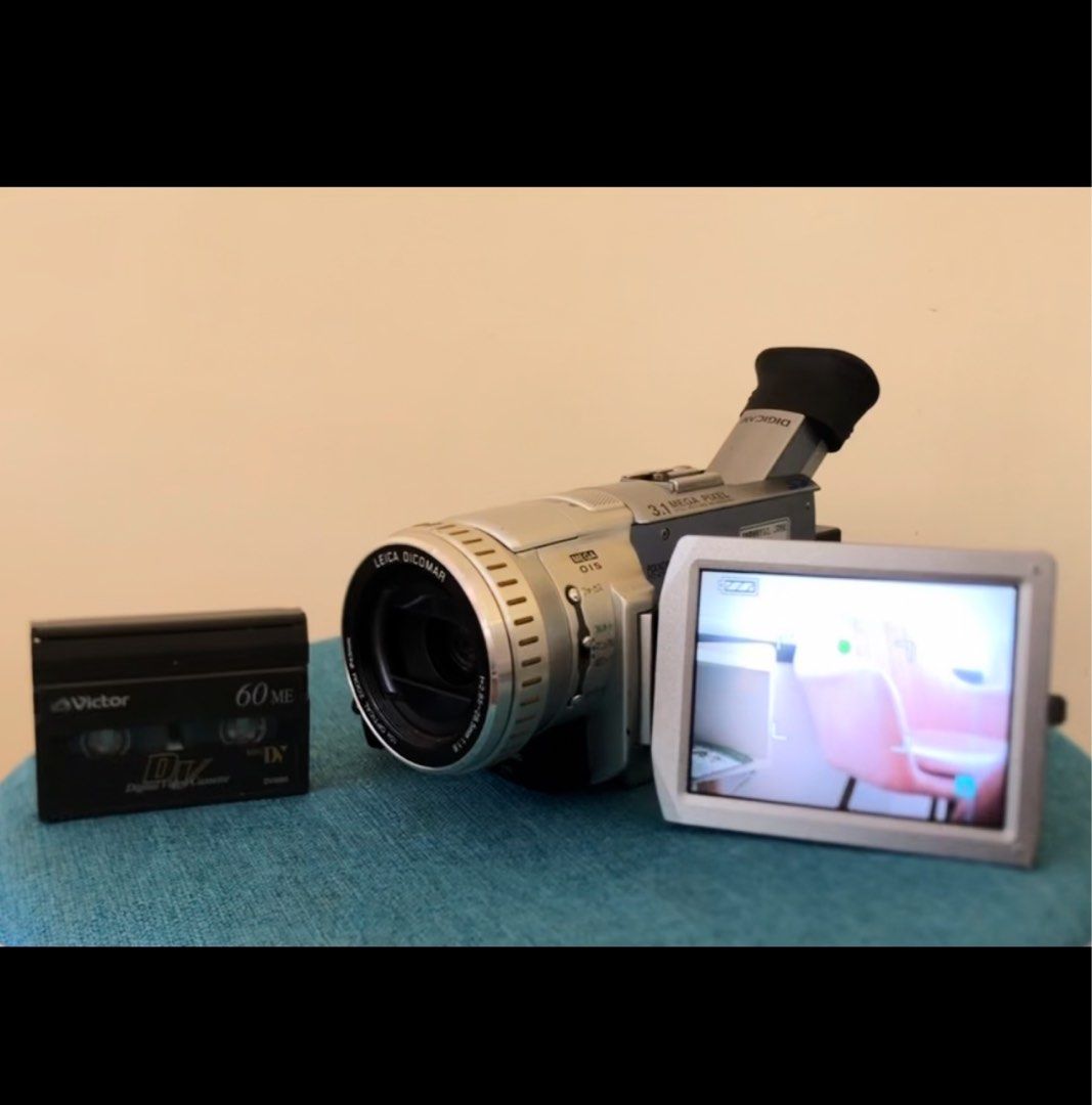 Panasonic NV-GS100 Mini DV / SD Camcorder - Digicam Combo (Category: Video Cameras) located in Makati City. Submitted by maka-luma (Listing ID 1316927000, Image 2). Description: FULLY WORKING (mint condition) ✔️ Record ✔️ Smooth Servo Zoom ✔️ Rewind ✔️ Pause/Stop ✔️ Fast forward ✔️ Color Viewfinder ✔️ Color LCD ✔️ Manual ✔️ Tape eject ✔️ SD Card Slot, camera snap mode ✔️ Diverse settings ₱6999 READY TO USE! 📹📼🔋Inclusions: Camera unit, Panasoni