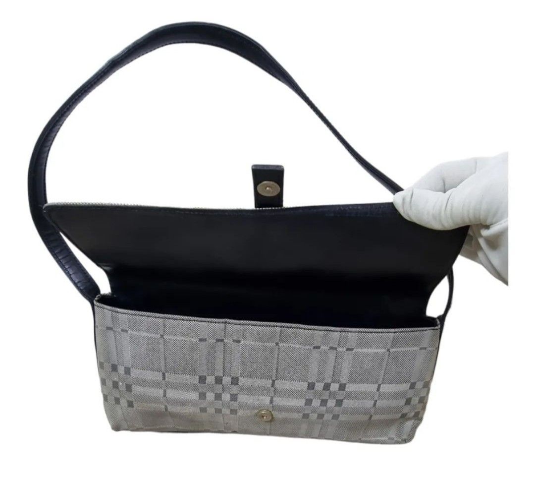 Authentic BURBERRY Bagguette bag (Category: Luxury Bags & Wallets) located in Quezon City. Submitted by maneradesignersboutique (Listing ID 1317011741, Image 2). Description: Money back Guarantee 💯% Guaranteed authentic *Brand: BURBERRY Bagguette bag *Materials: Canvas *Color: gray black *Size: small -Medium *Condition: 8/10 never been spa -Used * Inclusions: dustbag All items purchased from manera has less 30% Discount in restoration lifetime. 