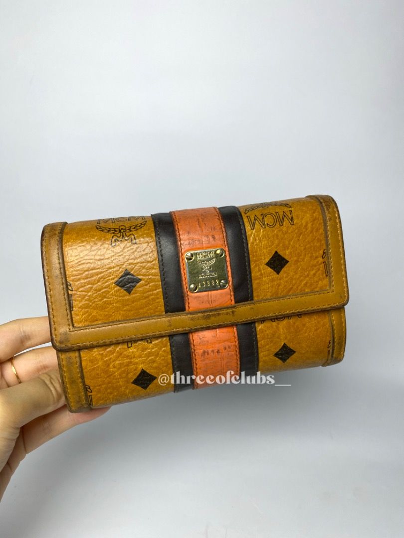 MCM Visetos Cognac Medium Trifold Wallet (Category: Luxury Bags & Wallets) located in Quezon City. Submitted by threeofclubs__ (Listing ID 1312274624, Image 2). Description: Very good condition 100% GA Clean leather body Clean leather interior Bill slot, card slots, clear picture frame No rubs No cracks Minimal dirt stains Other signs of usage always zoom photos ♣ 1 day reservation only. ♣ Please manage your expectations when buying preloved item