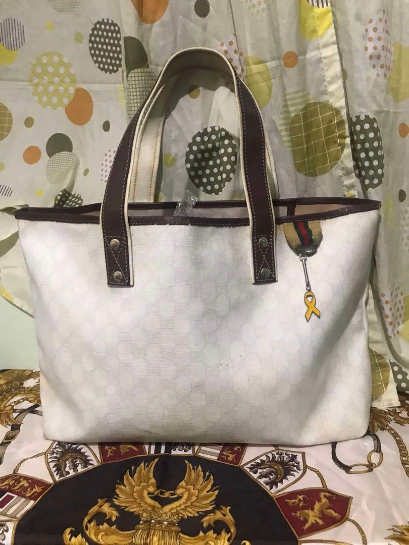 Gucci tote bag (Category: Luxury Bags & Wallets) located in Caloocan City. Submitted by bingsky312 (Listing ID 1317503270, Image 1). Description: Gucci cherry line With yellowish canvas and inner lining on some portion. Some tears on the leather piping along lips. No holes.