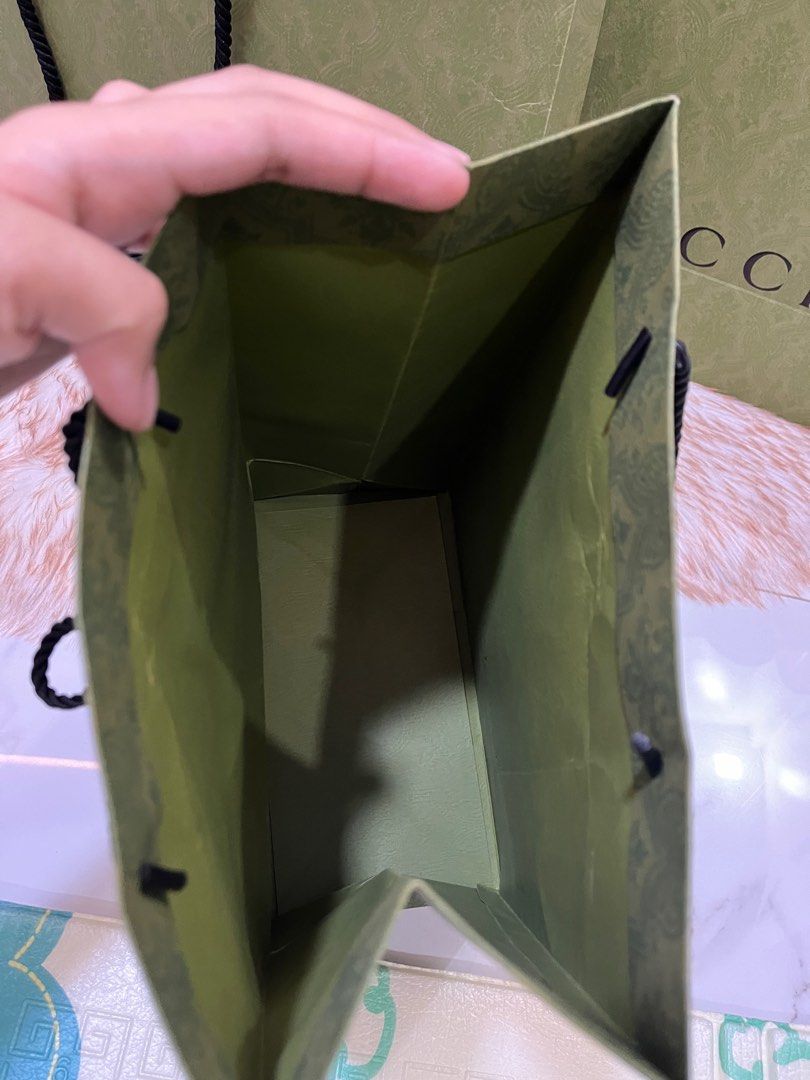 Authentic Gucci Green Paperbag (Category: Luxury Bags & Wallets) located in Quezon City. Submitted by jewelraestoyshop (Listing ID 1312325590, Image 3). Description: Authentic Gucci Green Embossed Paperbag Unfolded Unused Can send proof of authenticity from our Gucci purchases in Europe Large Size: H36 x L48 x W17 cm ₱1,000 per pc 2 pcs available Small Size: H32 x L24 x W13 cm ₱800 per pc 1 pc available .