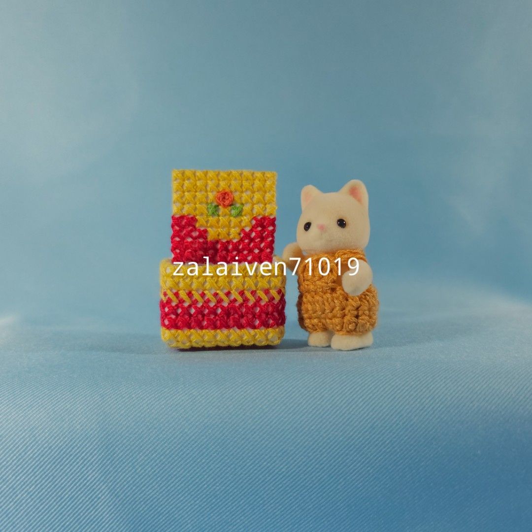 Sylvanian Families | Silk Cat baby with magenta and yellow bed (Category: Vintage Collectibles) located in Manila. Submitted by zalaiven71019 (Listing ID 1301466389, Image 2). Description: The baby was kept in storage away from light and in a smoke-free house. It is like new. The bed is handmade cross-stitch and the romper is crochet, all included in your purchase. I am currently decluttering and am selling things I don't have space for anymore. 