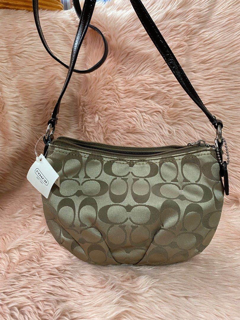 COACH small slingbag (Category: Luxury Bags & Wallets) located in Quezon City. Submitted by goodstuff_4sale (Listing ID 1312503613, Image 2). Description: new w tag COACH signature sateen swing pack/crossbody/ shoulder bag sv / khaki/mahogany jacquard fabric strap not adjustable embossed medallion pull tab 9 x 6.5 x 1.5” cute Gcash grab lalamove jrs j&t .