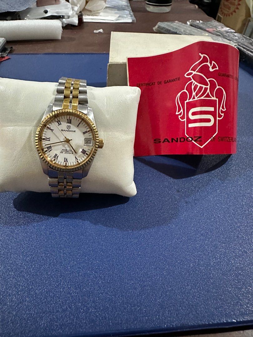 Sandoz Automatic Swiss Watch (Category: Luxury Watches) located in Quezon City. Submitted by carl.sy. (Listing ID 1312490556, Image 3). Description: Rare Sandoz automatic classic white dial, two-toned stainless steel bracelet. Date-just , automatic Swiss movement. Rolex Date-just look-alike, elegant sparkling fluted bezel. With see-thru back casing and with original Sandoz box and Guarantee Certificate. Made in Switzerland.