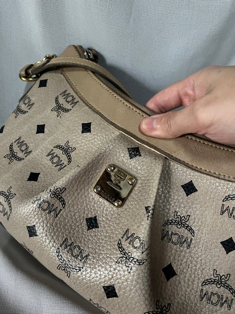 MCM Beige Shoulder Bag (Category: Luxury Bags & Wallets) located in Trece Martires City. Submitted by imwelllovedvintage (Listing ID 1282314825, Image 3). Description: ❗️No return, no exchange unless proven fake by professional authenticators❗️ MCM Beige Shoulder Bag •perfect kili bag • can fit a lot • slight dirt and stains sa exterior • signs of use sa hardware • fading sa print but barely noticeable • slight stains inside • piping buo pa ❌LOW 