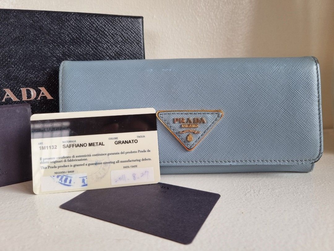 Prada Saffiano Metal Granato (Category: Luxury Bags & Wallets) located in Las Pinas. Submitted by janellskieee11 (Listing ID 1312692453, Image 2). Description: Personal preloved Original Prada long wallet with rubs at the corner of the wallet with box and cards light blue color may differ due to lighting.