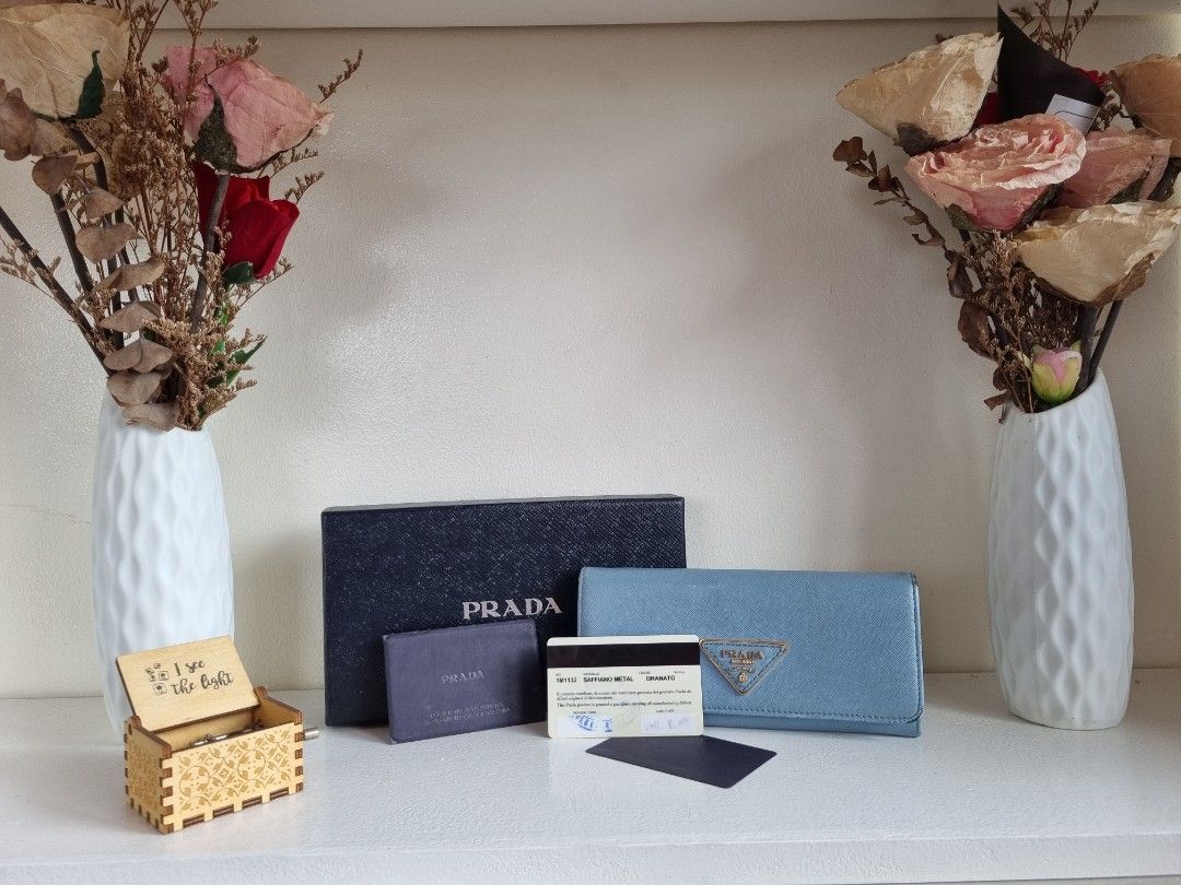 Prada Saffiano Metal Granato (Category: Luxury Bags & Wallets) located in Las Pinas. Submitted by janellskieee11 (Listing ID 1312692453, Image 1). Description: Personal preloved Original Prada long wallet with rubs at the corner of the wallet with box and cards light blue color may differ due to lighting.