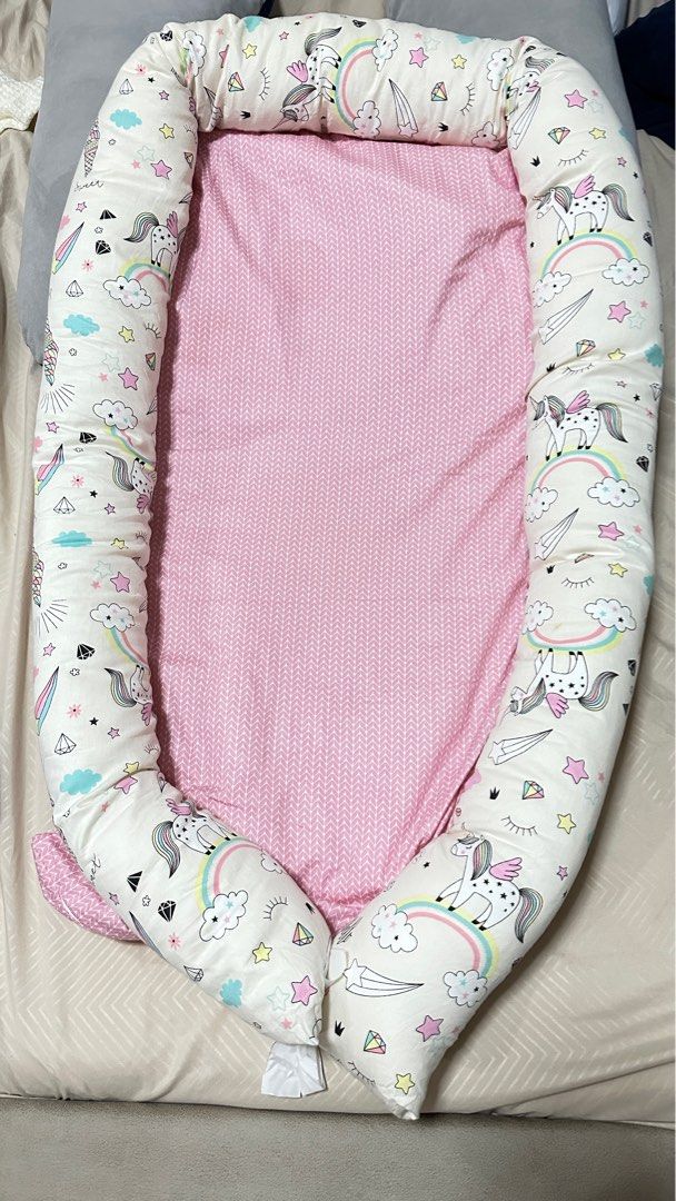 Mambo Bed Nest - Unicorn (Category: Cots & Cribs) located in Quezon City. Submitted by debbiejaneang (Listing ID 1312837274, Image 1). Description: Mambo nest bedding set is a portable and travel bed, a play mat and even a diaper changing mat and a co sleeper. This newborn baby products are firm but soft foam mattress gives extra support and comfort. Ribbons can be opened ,simply loosen the ribbon at the end of the bumpers to make the size larger