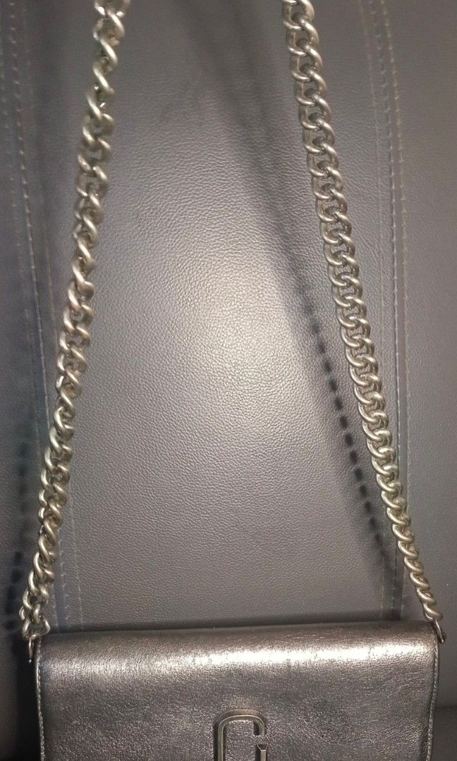 Marc Jacobs chain sling/clutch (Category: Luxury Bags & Wallets) located in Legazpi City. Submitted by georgepineda791 (Listing ID 1313105116, Image 2). Description: Preloved Marc Jacobs Leather Clutch Originally sourced from an Ukay selection, this stylish Marc Jacobs clutch is a sample release, as indicated by the tag stating "Not to be sold." The clutch features slots for a sling but did not come with one. I have added a matching chain sling t