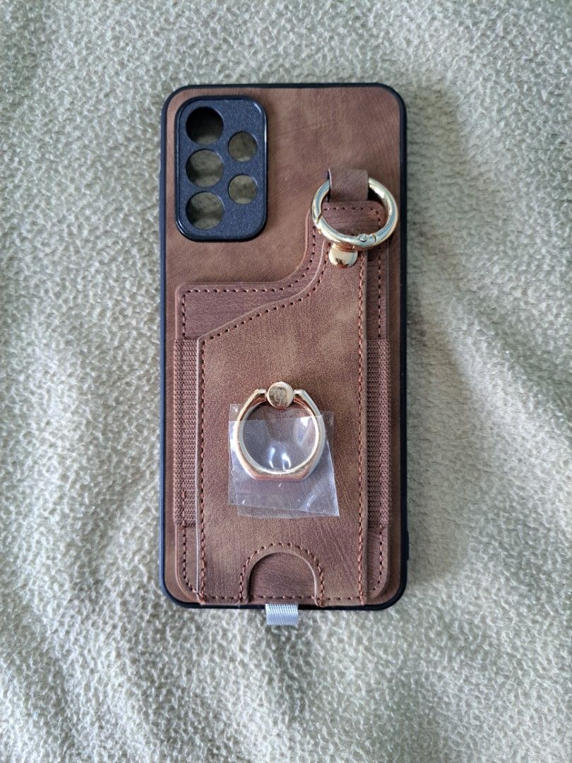 Sleeve case for Samsung A23 brown leather (Category: Cases & Sleeves) located in Mandaluyong City. Submitted by luckystorm_b5f979 (Listing ID 1313066727, Image 3). Description: Leather backed case for Samsung A23 has sleeve for cash cards built-in ring stand rfs: ordered the wrong case.