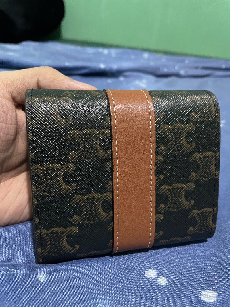 CELINE WALLET (SMALL TRIFOLD WALLET IN TRIOMPHE CANVAS) (Category: Luxury Bags & Wallets) located in Quezon City. Submitted by jakescollection (Listing ID 1317669507, Image 2). Description: CELINE SMALL TRIFOLD WALLET IN TRIOMPHE CANVAS Dimensions: 10.5 x 8.5 x 4 CM flap closure with snap buttons 5 card slots 1 cash pocket 1 coin purse Includes box, dust bag and chain strap.