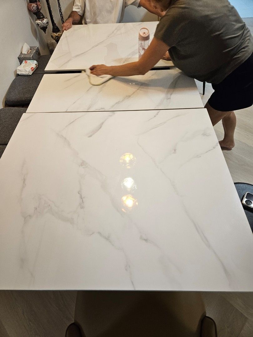Dining Table (Category: Tables & Sets) located in Singapore. Submitted by donjulo (Listing ID 1317570821, Image 3). Description: L160/200cm x W90cm x H75cm. 160cm and extendable to 200cm table. Almost brand new . Extendable Sintered Stone Table with 2 chairs. Original price was $1300. Table comes with hidden induction cooker in the centre. Please arrange for own collection and delivery..