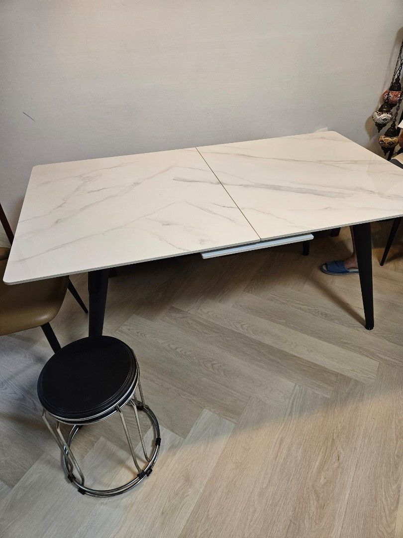 Dining Table (Category: Tables & Sets) located in Singapore. Submitted by donjulo (Listing ID 1317570821, Image 1). Description: L160/200cm x W90cm x H75cm. 160cm and extendable to 200cm table. Almost brand new . Extendable Sintered Stone Table with 2 chairs. Original price was $1300. Table comes with hidden induction cooker in the centre. Please arrange for own collection and delivery..