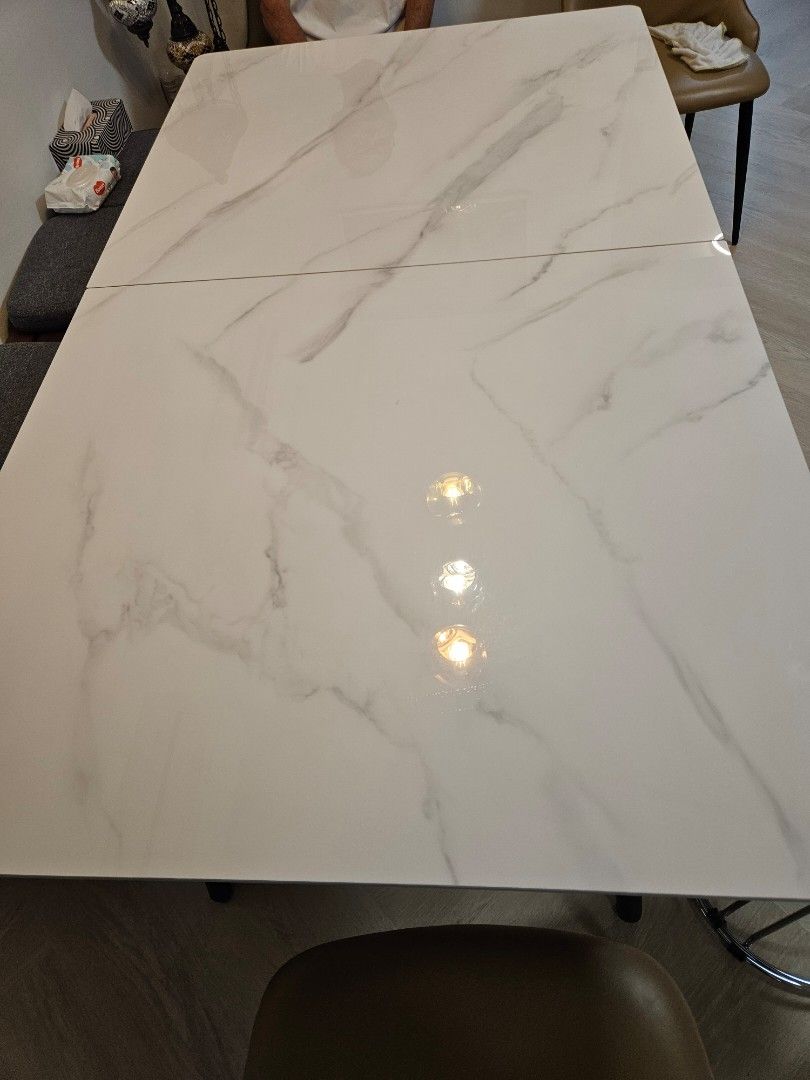 Dining Table (Category: Tables & Sets) located in Singapore. Submitted by donjulo (Listing ID 1317570821, Image 2). Description: L160/200cm x W90cm x H75cm. 160cm and extendable to 200cm table. Almost brand new . Extendable Sintered Stone Table with 2 chairs. Original price was $1300. Table comes with hidden induction cooker in the centre. Please arrange for own collection and delivery..