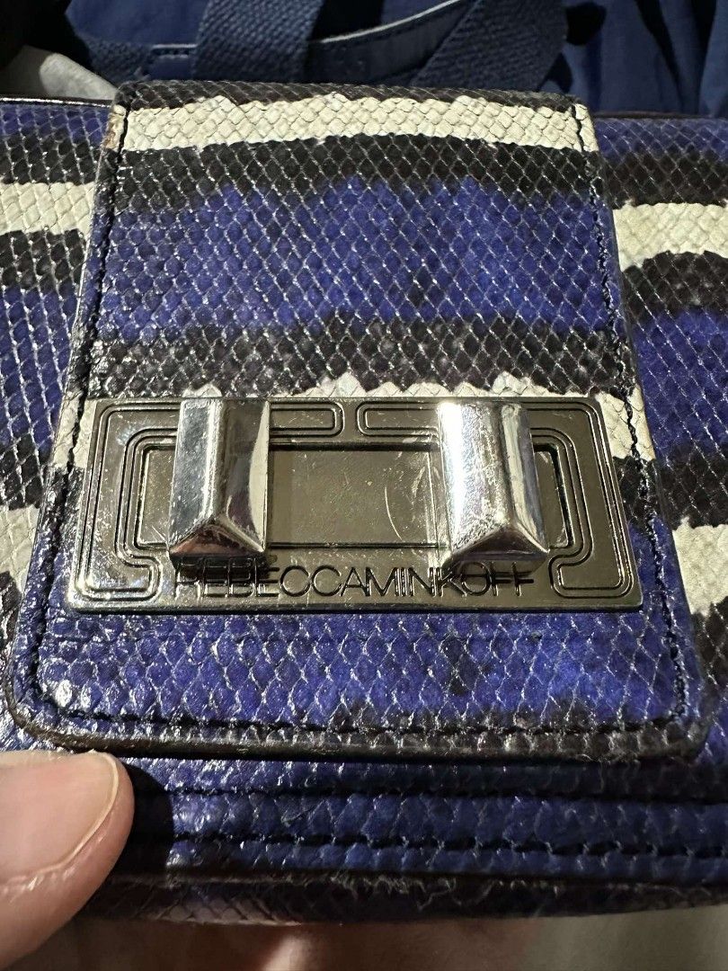 Rebecca Minkoff - Sling bag (Category: Luxury Bags & Wallets) located in Quezon City. Submitted by offthesehands (Listing ID 1317691904, Image 2). Description: Brand: Rebecca Minkoff (Authentic from Japan) Color: snake texture, tri color Type: sling bag Size: 11x16cm does not fit iphone pro max Usage: with signs of usage, leather slightly faded RFS: Decluttering DM if interested | Will only entertain questions related to the item.