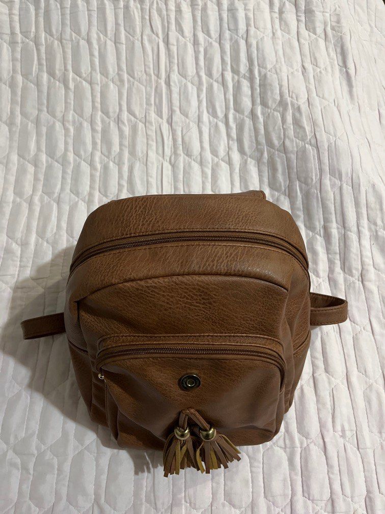 Brown leather backpack (Category: Backpacks) located in Quezon City. Submitted by leisdeclutter (Listing ID 1319254743, Image 3). Description: - Still good quality - only issue is may yellowing stains na sa loob - no brand, bought from US loc: libis, qc .