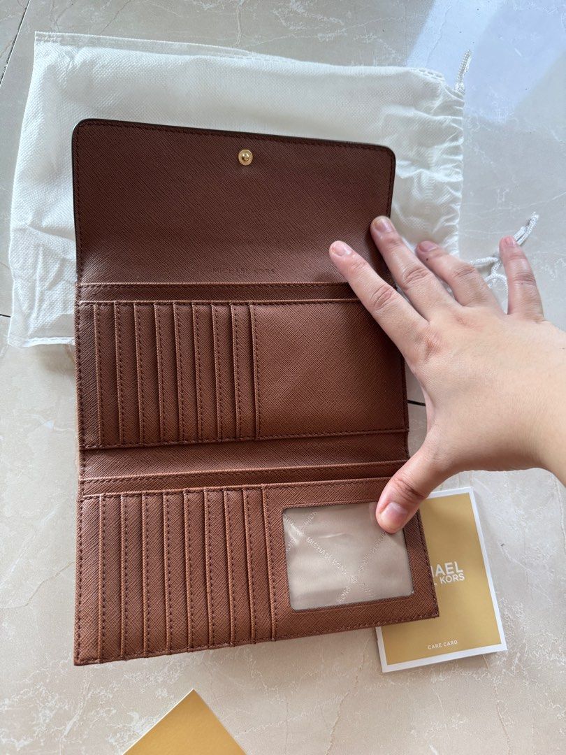 Michael Corrs long brown leather wallet (Category: Luxury Bags & Wallets) located in Pasig City. Submitted by djalex947 (Listing ID 1319251363, Image 3). Description: Never been used with authentication cards Bought in the US for $188.