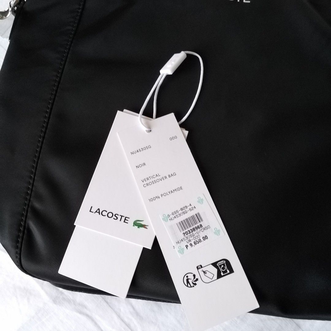 Lacoste Nylon Vertical Tote Bag (Category: Tote Bags) located in Cainta. Submitted by roweb (Listing ID 1319608438, Image 3). Description: Lacoste Tote/Crossbody bag Made of nylon, with removable strap. Pls. see # 10 photo for complete description.. Original price P9650. Will pass as brand new. Received as a gift, tried at home but it's a bit big for my taste. Last 3 pics from the net. CTTO.