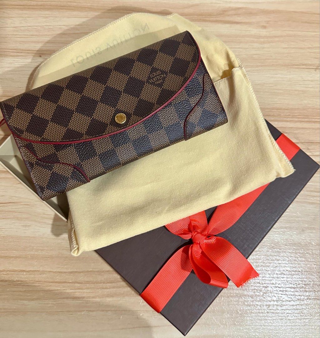 Louis Vuitton Damier Ebene Caissa Wallet (Category: Luxury Bags & Wallets) located in Angono. Submitted by carefree03 (Listing ID 1319629938, Image 1). Description: 💯 Authentic Louis Vuitton Caissa Wallet Details: Size (L x H x W) 19 x 10 x 2 cm Color: Damier Ebene, Cherry Red Material: Canvas Condition : Excellent Serial / Datecode: CA0196 Comes with box and dust bag #louisvuitton #luxury #wallet #original.