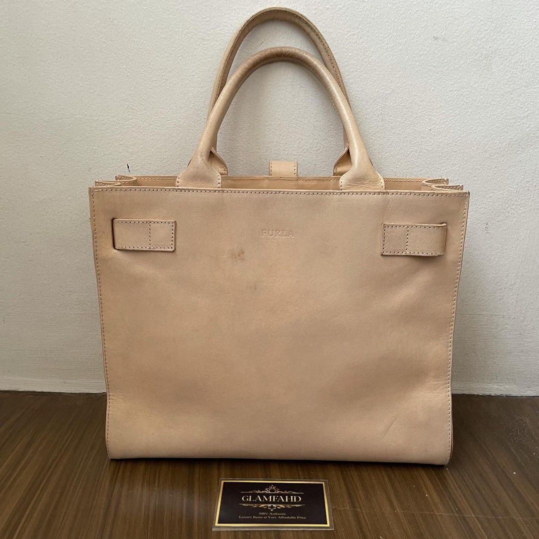 Pre Owned Authentic FURLA Leather Handbag (Category: Luxury Bags & Wallets) located in Paranaque City. Submitted by Glamfahd (Listing ID 1319584123, Image 3). Description: PRE OWNED AUTHENTIC FURLA BAG Features Beige Leather Measurements: 11.5x9x4.5 inches Drop 5 inches Interior zip pocket Inclusion/s: None Condition Used condition Some signs of use Bag is really a great buy! Please see photos to appreciate.