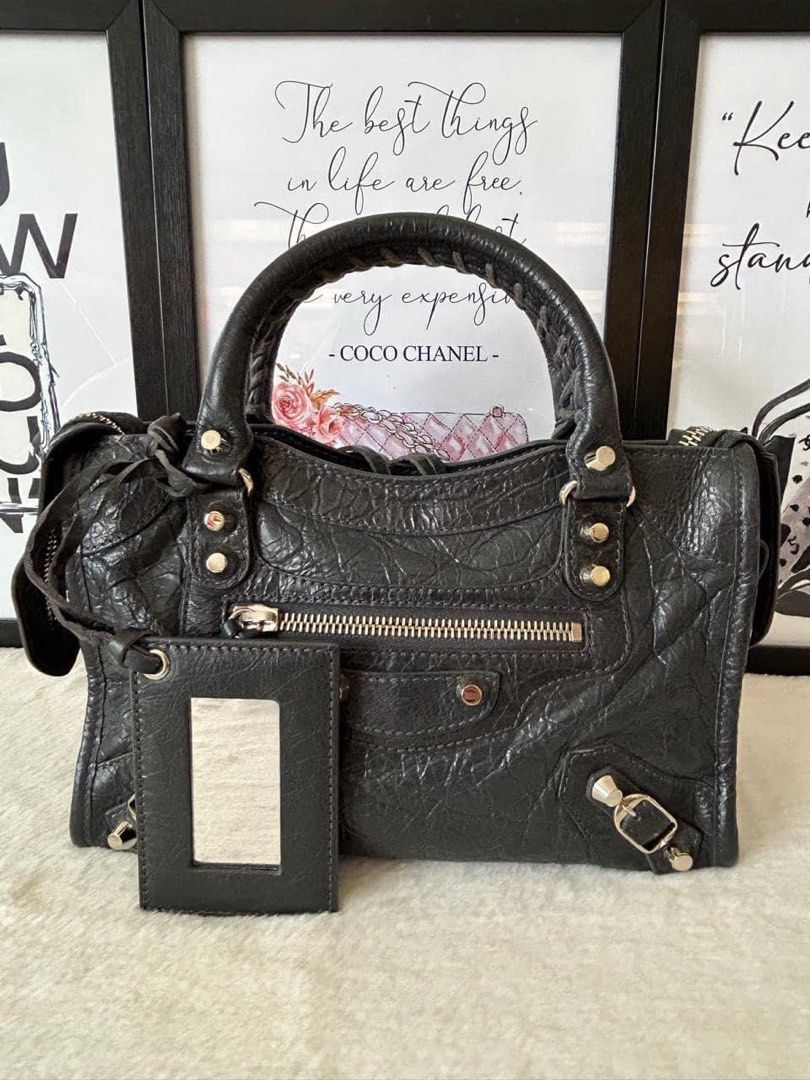 Mini City Logo Strap Bag (Limited Ed./ New Version) (Category: Luxury Bags & Wallets) located in Manila. Submitted by bagislifeshop (Listing ID 1320236352, Image 2). Description: ☑️Available in Pampanga ✅Condition: 9/10 ✅Colour: Dark gray in SHW ✅Material: Lambskin ✅Inclusions: Dustbag, cards, mirror and logo strap .