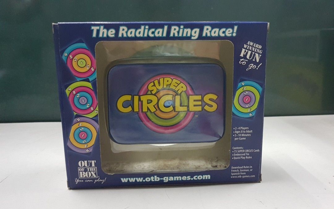 Super Circles The Radical Ring Face card game (Category: Board Games & Puzzles) located in Quezon City. Submitted by whizdepot (Listing ID 1319747359, Image 1). Description: "Super Circles: The Radical Ring Race! Players race to play all their cards by matching colored rings on the previously played card. Quick minds and fast fingers will triumph!" Part of the publisher's Fun to Go card game series, this tin contains 72 cards, each picturing 4 co