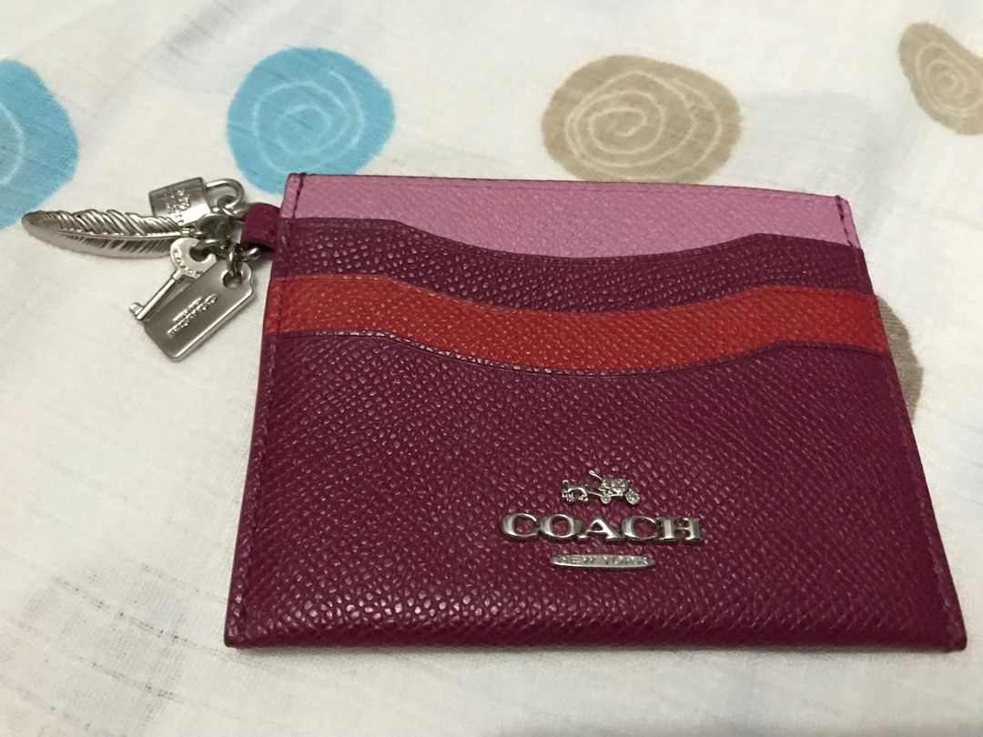 Coach Multicolor Card Holder (Category: Luxury Bags & Wallets) located in Santa Rosa. Submitted by rina.rina3 (Listing ID 1320495472, Image 1). Description: Coach multicolored card holder Sourced from Korea With Coach hang tag, and 3 other charms (feather, padlock and key) Super cute in person Buyer to shoulder shipping fee Slightly negotiable .