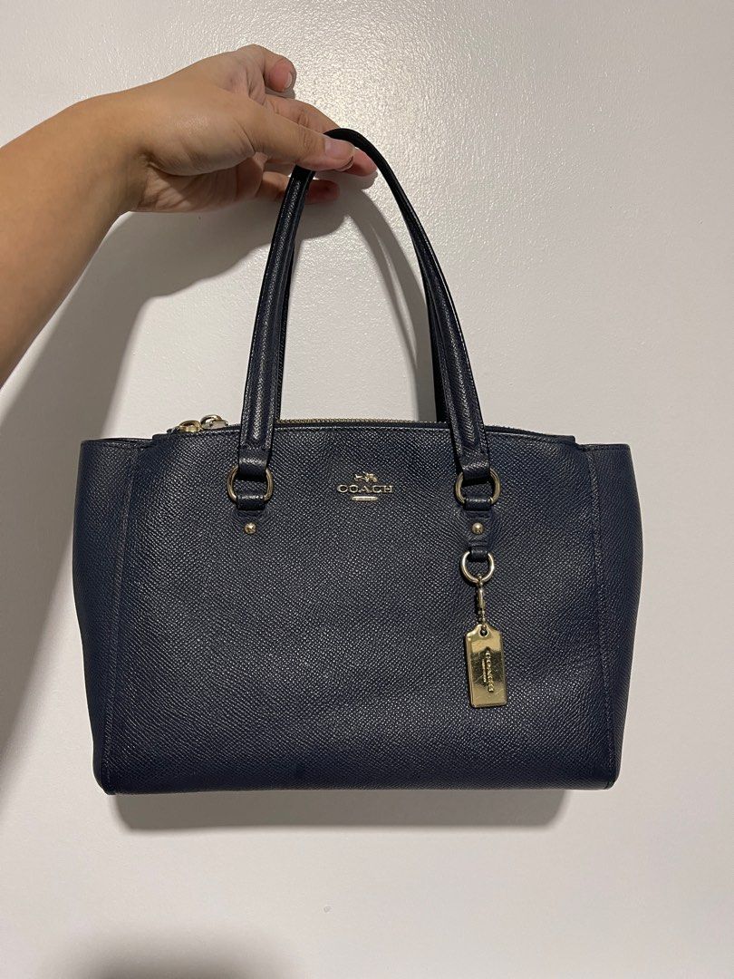 Coach Stanton Carryall Shoulder Sling Bag (Category: Shoulder Bags) located in Cavite. Submitted by lengthingz (Listing ID 1320545631, Image 2). Description: SALE!!! FOR ONLY 2,000!! ✨ condition: 9/10 ✨ only issue is replaced with ka-color na sling. (lovcat sling) same na same color 😍 not noticeable na replaced. Color: Navy/Midnight Blue Material: Leather Hardware: Gold with hang tag Dimensions: 9.5”x7”x4” - Item Location: Imus, Cavite rfs: decl