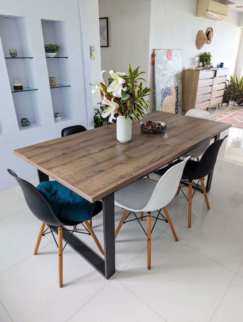 Extendable dining table (Category: Tables & Sets) located in Singapore. Submitted by marcollo (Listing ID 1320475067, Image 2). Description: Solid and functional extendable table. The top is made of laminated wood panels, that only have minor defects in some edges where the lamination has lifted up a little (see last pictures). The legs are made of strong and sturdy metal material. Legs can be unscrewed and detached, in order to move it to the ne