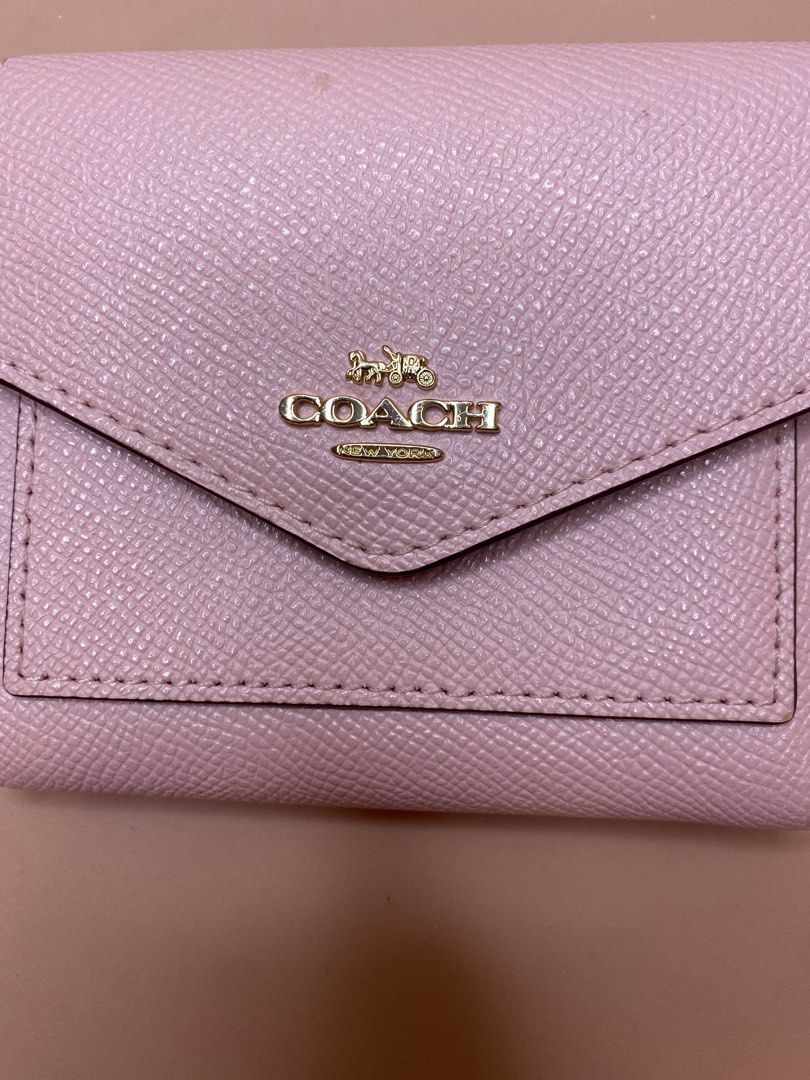 ♡ C O A C H [Trifold Wallet] (Category: Luxury Bags & Wallets) located in Valenzuela. Submitted by cityandsea (Listing ID 1320621909, Image 2). Description: ♡ C O A C H - [Leather Hook Tri-Fold Wallet] 🏷️ ₱2,800 Rank AB [very good condition, with minor but negligible signs of use] * 100% Authentic * Leather Hook Tri-Fold Wallet * Size: W 11cm x H 10cm x D 2cm * Color: Light Pink * Color may vary due to photographic lighting * Super nice in perso