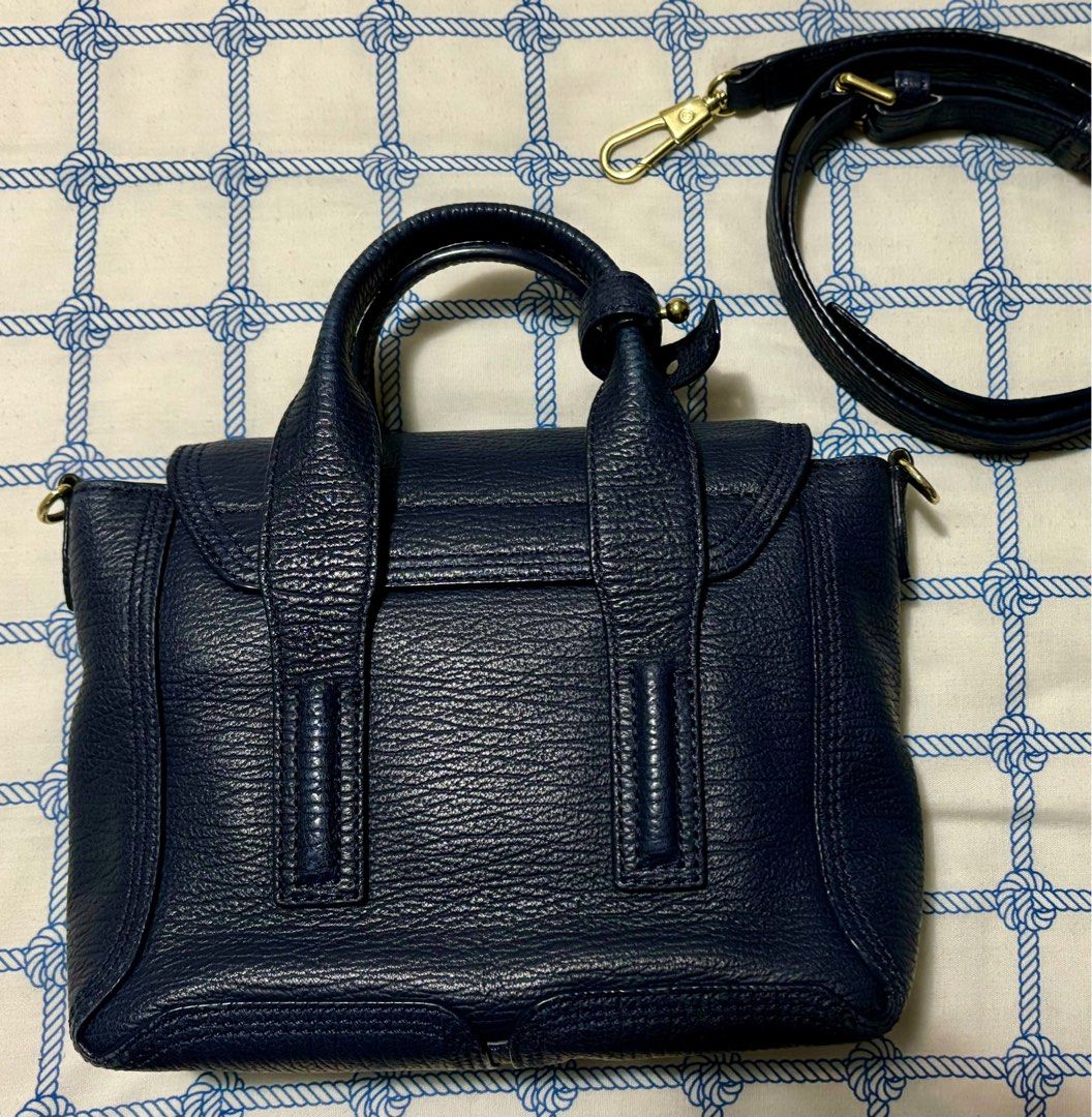 Sale! Pashli Phillip Lim (Category: Cross-body Bags) located in Taguig. Submitted by museumile (Listing ID 1320691425, Image 3). Description: Authentic Pashli by Phillip Lim two-way bag in dark blue. Very cute! Comes with detachable & adjustable strap. Bought in LA for P31k. RFS: Not using anymore. Size: 10x8x3 inches. No major flaws. Minor rub only on back bottom corner, scratches on front hardware (see photos). Clean inner lining. Zippers are a