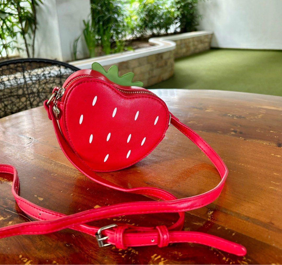 Uncage strawberry crossbody micro bag in red (Category: Cross-body Bags) located in Pasig City. Submitted by lexans_bentables (Listing ID 1320695681, Image 2). Description: Uncage strawberry crossbody micro bag in red ❣️ CLEARANCE SALE ❣️ - super cute micro bag with strawberry design - can fit card holder and small bifold wallet - long, adjustable strap - normal signs of use NOTE❗️❗️❗️ - lining has stain as can be seen in the last pic, but not st