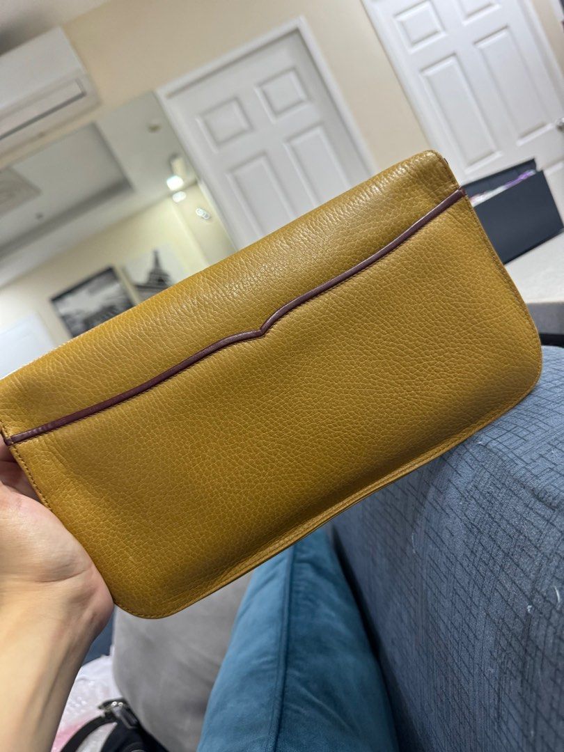 Authentic Cartier Leather Clutch Bag Yellow (Category: Clutches) located in Manila. Submitted by ganned (Listing ID 1317862734, Image 2). Description: Cartier Clutch Bag in Yellow with Authentication card and dustbag Well taken cared of by owner Inside zipper still with protective plastic Clean interior Hardware all gold No rubs, loose stitches or piping issues.