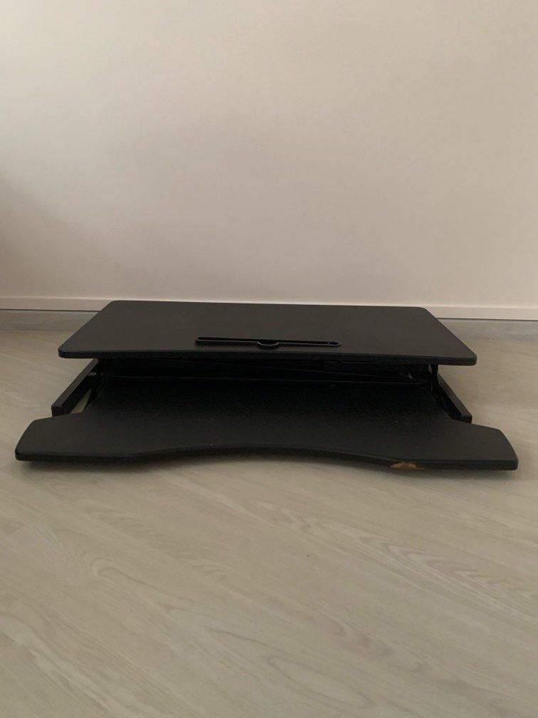 Adjustable 32in table riser/standing desk (Category: Office & Business Technology) located in Singapore. Submitted by swayt (Listing ID 1321136875, Image 1). Description: Standing desk with gas spring that allows you to adjust your workstation from sitting to standing 5.3” - 20.5” The top measures 80cm x 40cm and holds up to 15kg Originally bought for $150.