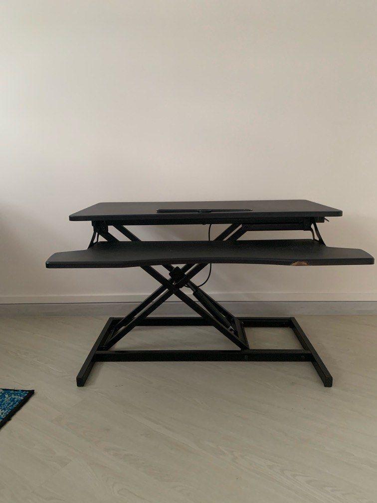 Adjustable 32in table riser/standing desk (Category: Office & Business Technology) located in Singapore. Submitted by swayt (Listing ID 1321136875, Image 2). Description: Standing desk with gas spring that allows you to adjust your workstation from sitting to standing 5.3” - 20.5” The top measures 80cm x 40cm and holds up to 15kg Originally bought for $150.
