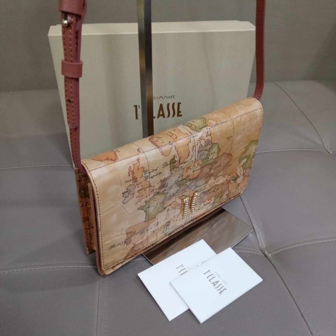 Alviero Martini Pochette With Flap Bag (Category: Luxury Bags & Wallets) located in Taguig. Submitted by esa.agustin (Listing ID 1321213936, Image 2). Description: Original Alviero Martini Pochette with flap sling bag. With box and carecard. in Neutral color. Bought in Italy..