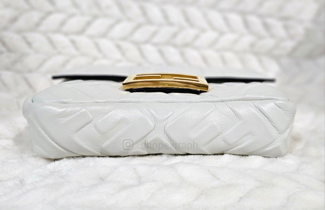 Fendi Baguette Mini (Category: Luxury Bags & Wallets) located in Paranaque City. Submitted by shopextraph (Listing ID 1321721881, Image 3). Description: Small iconic Baguette bag made of soft, white nappa leather with a 3D-effect embossed iconic FF motif and embellished with an FF clasp. Features a front flap, magnetic clasp, fabric-lined internal compartment with a pocket and gold-finish metalware. The bag can be carried by hand, or worn either 
