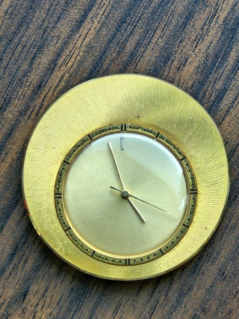 Jaeger-LeCoultre travel / table clock (Category: Luxury Watches) located in Las Pinas. Submitted by 05.11minimalist (Listing ID 1321653220, Image 1). Description: Jaeger-LeCoultre Memovox travel / table clock. Vintage. Rare. 1960s. Plain silver dial, with one baton as alarm marker, gold hands with center sweep. 50mm housing. Mechanical. Gold-tone. 2 crowns - 1 for setting main movement & winding; 1 for setting alarm & winding. Fold out stand. Cle