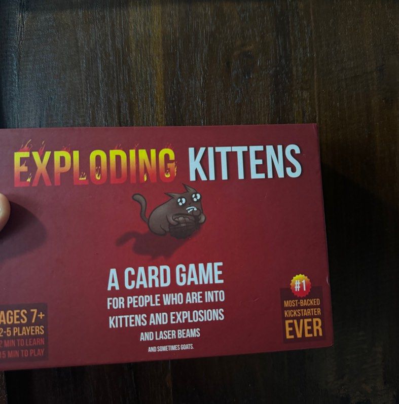 Exploding Kittens Card Game (Category: Board Games & Puzzles) located in Singapore. Submitted by blushwings (Listing ID 1321873926, Image 3). Description: Abit of dent on box. No cards missing. Includes manual..