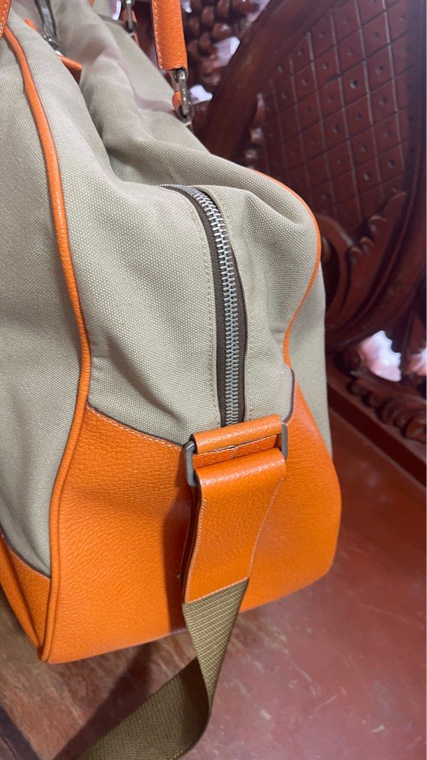 Authentic Prada travelling bag (Category: Luxury Bags & Wallets) located in Las Pinas. Submitted by tatz06 (Listing ID 1322026458, Image 3). Description: Guaranteed authentic. Personal owned bag. Have some little rubs in the edge but no open piping. Still in good condition. 17x8.5x13 in.