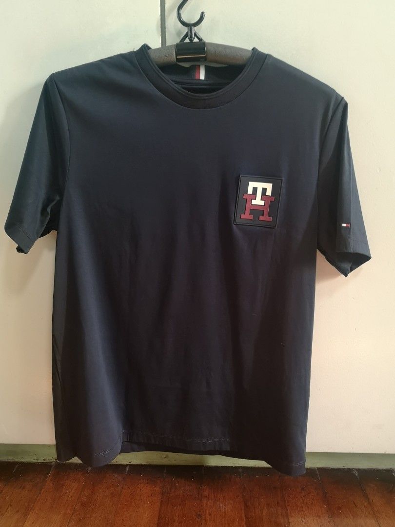 Tommy Hilfiger t shirt (Category: Tshirts & Polo Shirts ) located in Mandaluyong City. Submitted by japs2 (Listing ID 1322114912, Image 3). Description: Tommy Hilfiger shirt (authentic) P2,500 BLUE Size tag: medium (width 20inches,27 length) Never been used RFS: my size is medium slim fit, but this is medium regular fit. Big for me Mandaluyong/BGC area.