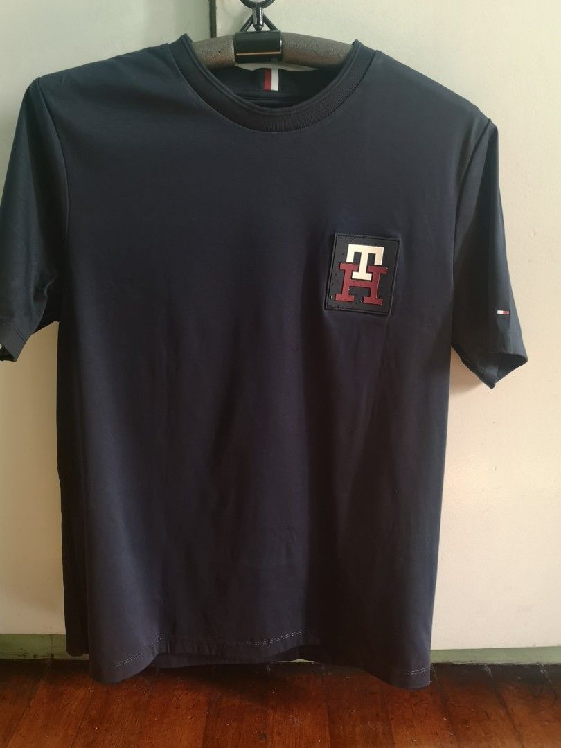 Tommy Hilfiger t shirt (Category: Tshirts & Polo Shirts ) located in Mandaluyong City. Submitted by japs2 (Listing ID 1322114912, Image 1). Description: Tommy Hilfiger shirt (authentic) P2,500 BLUE Size tag: medium (width 20inches,27 length) Never been used RFS: my size is medium slim fit, but this is medium regular fit. Big for me Mandaluyong/BGC area.