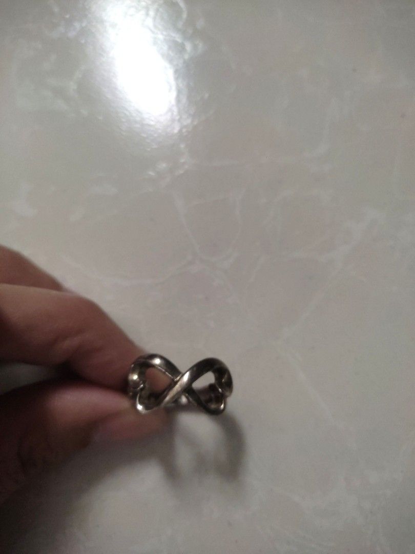 Original! Tiffany & Co. Infinity Silver Ring (Category: Rings) located in Las Pinas. Submitted by bibliomomma (Listing ID 1322237388, Image 2). Description: Guaranteed Authentic! Tiffany & Co. Infinity Ring Original receipt uploaded for your reference Excellent used condition, just needs cleaning Size 6 Money back guarantee if proven fake MOP Gcash.