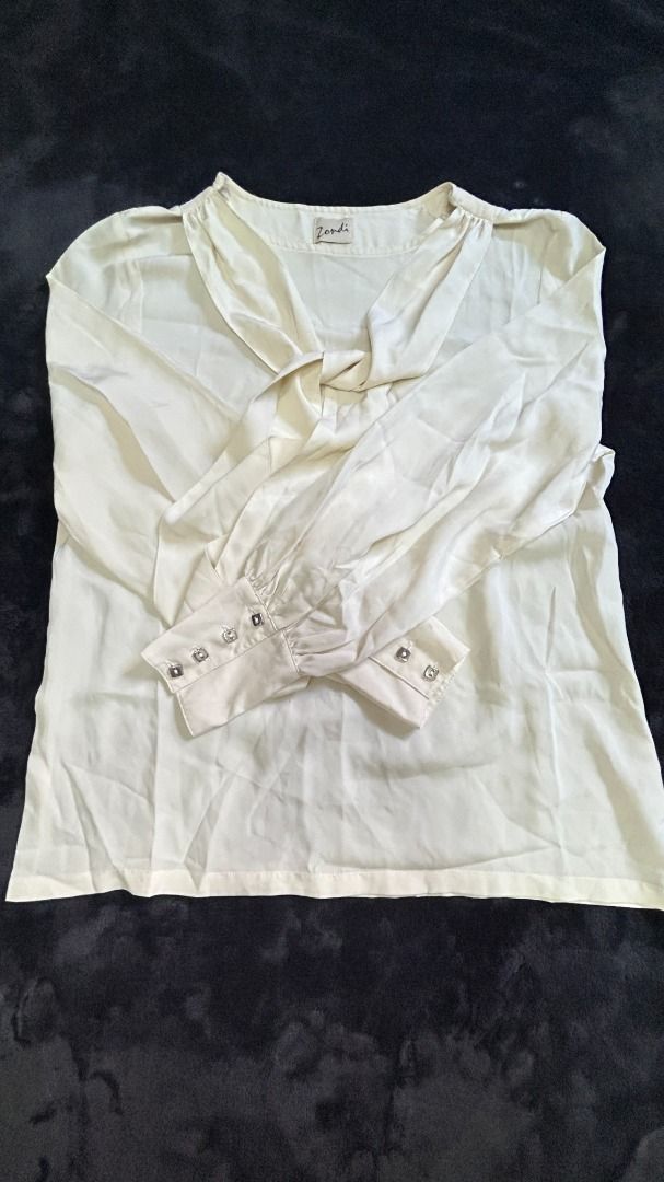 Womens Off-White Silk Long Sleeves Blouse (Category: Blouses) located in Pasay City. Submitted by mgagamitnichrish (Listing ID 1322318995, Image 1). Description: Size: Best fit Medium-Large Condition: Pre-loved but still in great condition 📍Pasay MOD: Lalamove or Grab Issue: small ballpen stain on collar part. please check the last image .